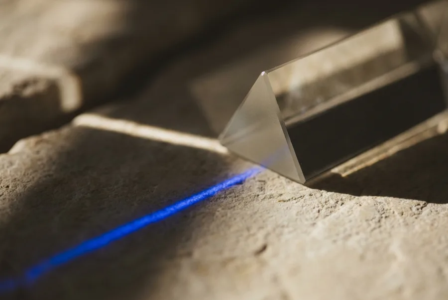 A glass prism splitting a beam of light