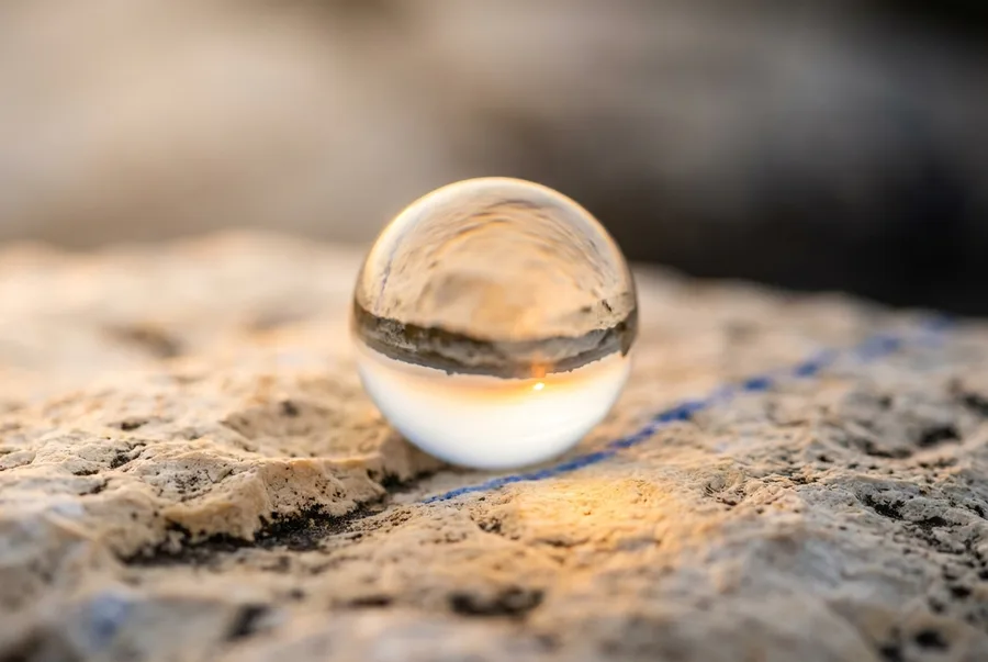 A glass sphere refracting light on limestone