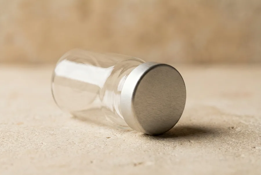 A compounding vial on limestone in raking light